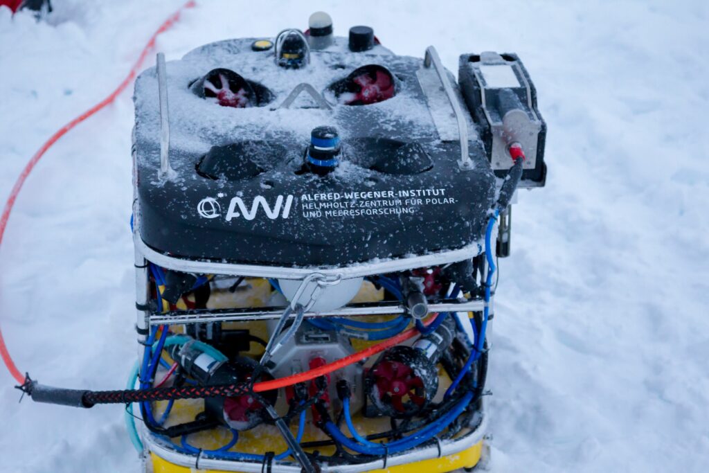 The NUI under-ice ROV is currently being lowered into the water.