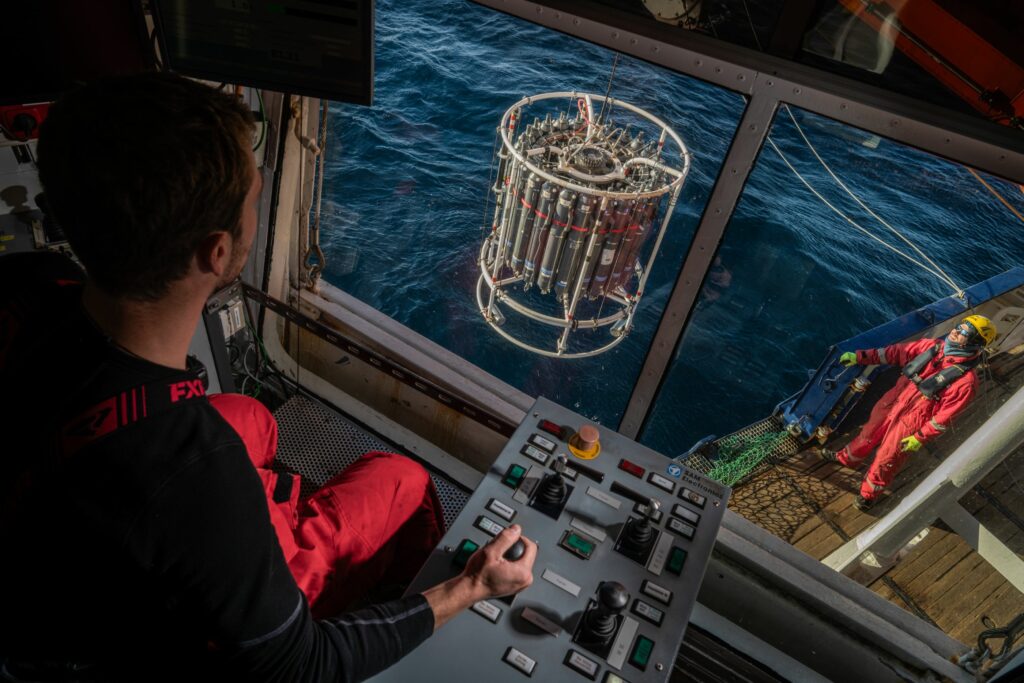 Deck crew deploys CTD for conductivity, temperature and density measurements in the water at different depths.