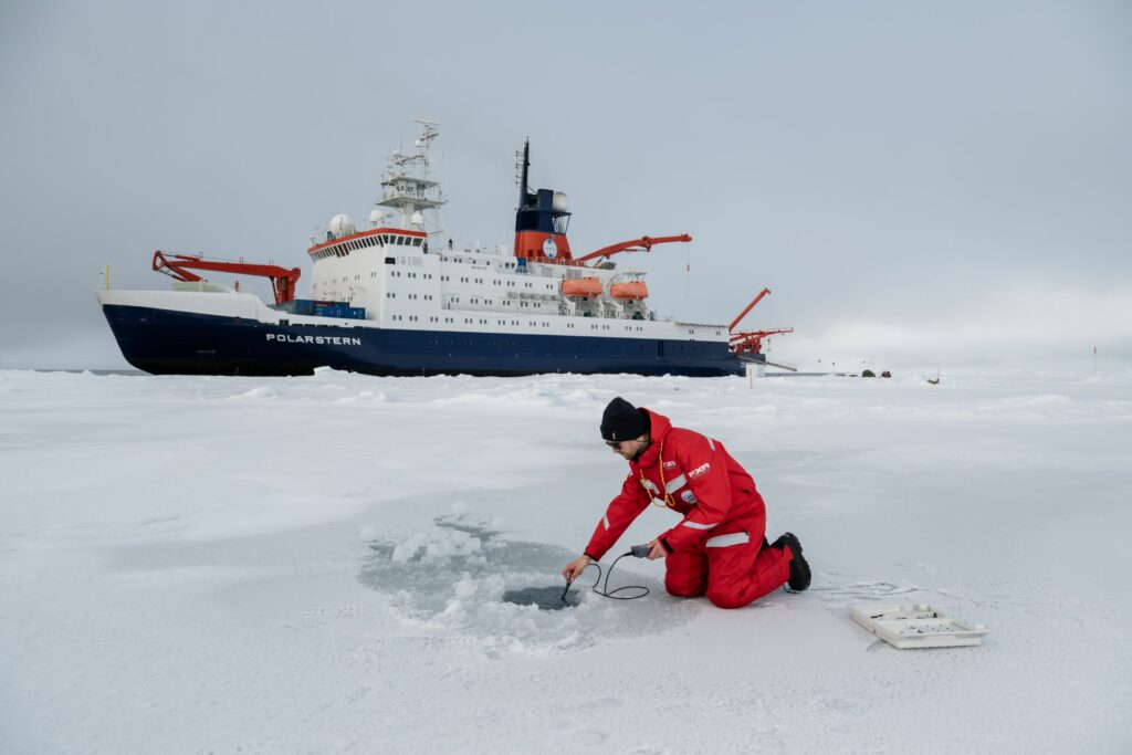 Measuring water temperature and salinity at an ice floe during ArcWatch expedition in the Arctic Ocean.